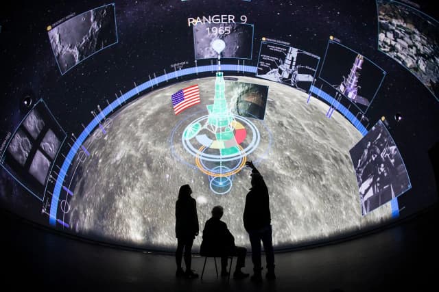 A group of people looking at a fulldome projection inside the Devonport Market Hall's 210-degree dome theater driven by Screenberry